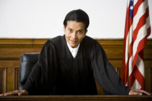 Portrait,of,a,female,judge,leaning,against,a,bench