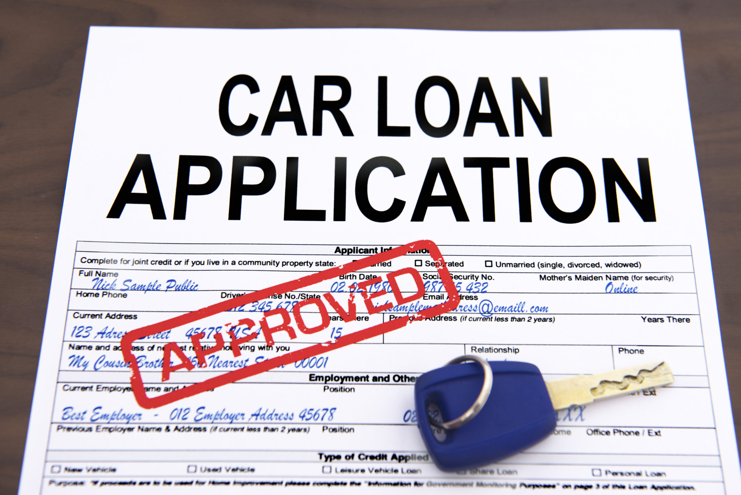 Approved,car,loan,application,form,and,key,on,desktop