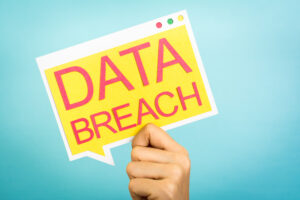 Hand,holding,a,speech,bubble,with,"data,breach",words.,security